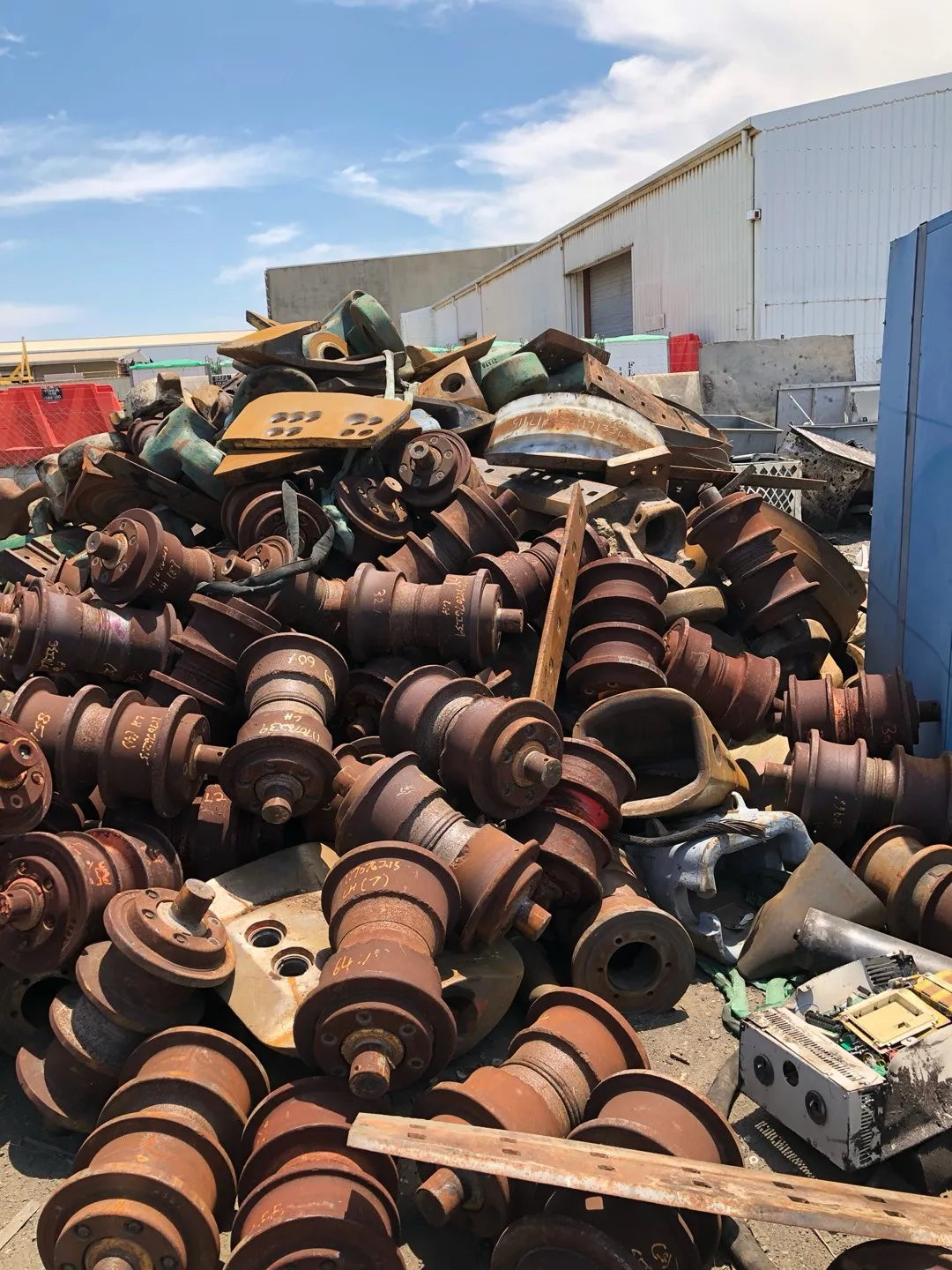 Stockpile of heavy steel mining equipment parts at the CMR Recycling yard.